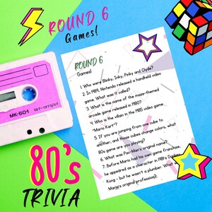 May include: A pink and white cassette tape with the text "MK-60-1 137-1973/57" on it. A pink and white card with the text "ROUND 6 Games!" and a list of trivia questions about 80s video games. The card is decorated with a pink and white star.