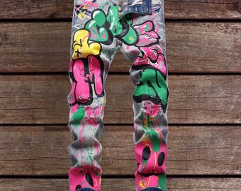 Vintaged men’s graffiti painted streetwear ripped denim jeans, slim fit, button fly , regular waisted, tapered cut , punk style,