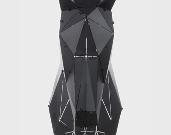 May include: Black geometric horse head sculpture made of metal. The sculpture is made up of many triangles and has a modern, minimalist design.