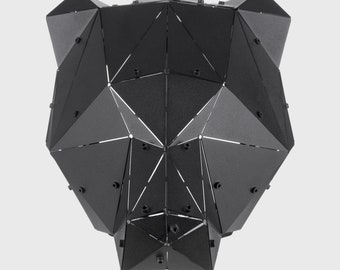 May include: Black metal geometric bear head sculpture. The sculpture is made of many small triangles and has a textured finish.