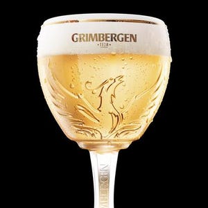 Beautiful Grimbergen 17 oz. glass chalice on foot with the Phoenix rising from the ashes logo. Rare Belgian beer glass. Collectible barware.