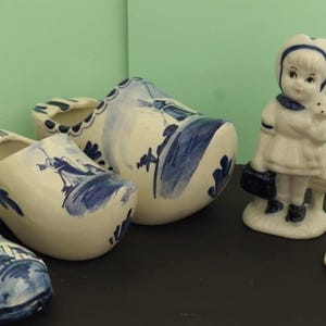 Delft blue collectible figurines. Medium Delft blue hand painted boy and girl. Delft blue shoe ashtrays. Hand painted Dutch clogs. Souvenirs