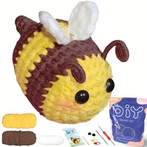 May include: A crochet bee kit featuring a finished plush bee with yellow and brown stripes, white wings, and black eyes. The set includes yellow, brown, and white yarn skeins, a crochet hook, two black safety eyes, stitch markers, and a DIY instruction card.