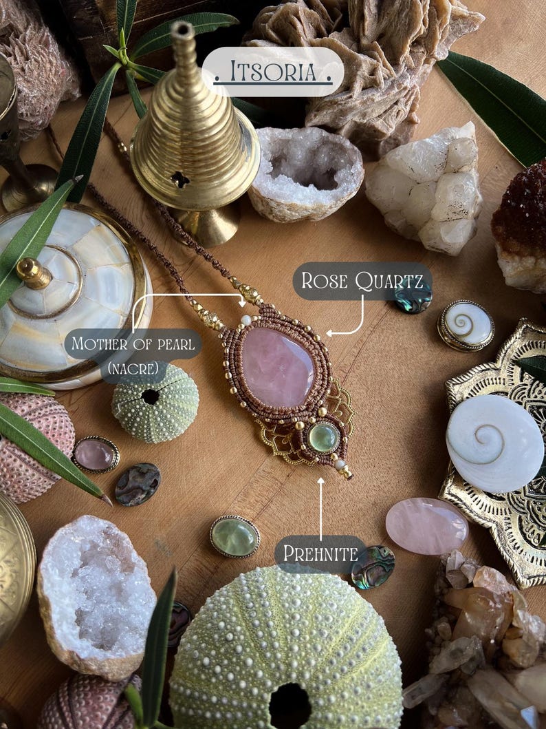 May include: A handcrafted necklace with a large rose quartz pendant, accented with gold-colored beads and brown cord. The image also features various gemstones, sea urchins, and the text "ITSORIA".