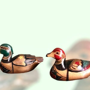 Pair of vintage ducks with hand painted floral decorations in wood