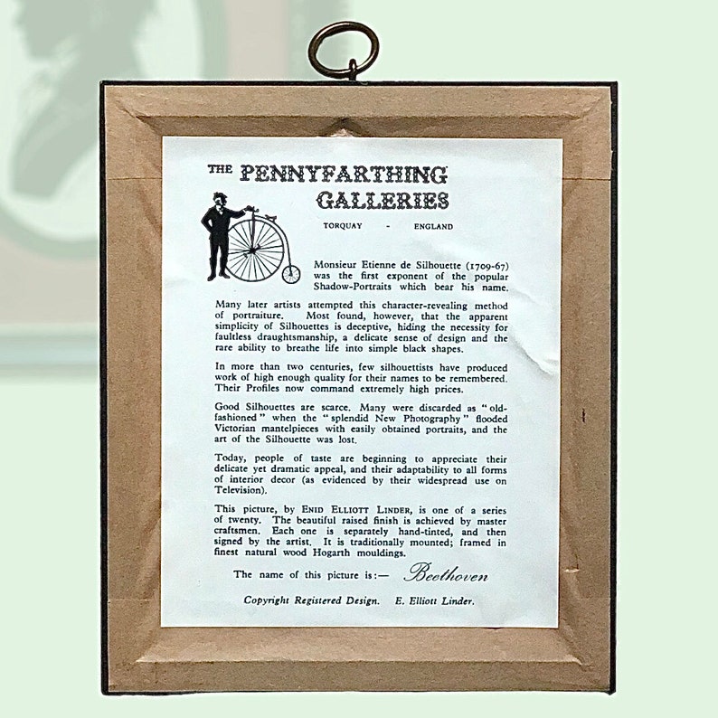 Puede incluir: Una silueta en blanco y negro enmarcada de una persona con el texto "The Pennyfarthing Galleries" y "Beethoven" impreso debajo de la imagen. El texto tambi&eacute;n incluye informaci&oacute;n sobre la historia de las siluetas y la artista Enid Elliott Linder.