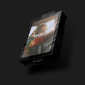 May include: A black box with a clear plastic cover. The box has the text "Dramatic LUTS Collection" on it. The image inside the box shows a person wearing a colorful scarf in a car.