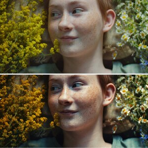 May include: A close-up of a young person with freckles lying on a bed of yellow and white flowers. The person is smiling and looking to the right. The flowers are in focus, while the person's face is slightly out of focus.