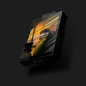 May include: A black box with a clear plastic cover, showcasing a person sitting in a bus. The box has the text "CINEMATIC LUTS COLLECTION" on it. The image has a warm, cinematic feel.