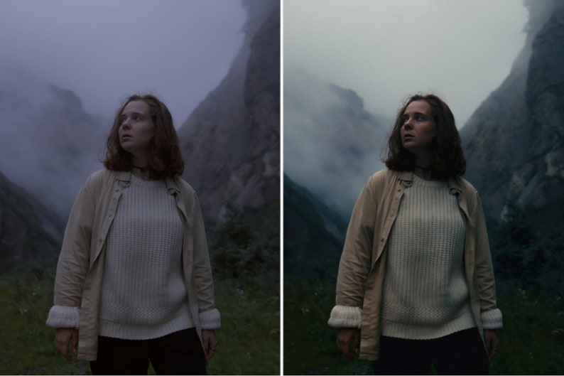 May include: A woman wearing a white jumper and a beige jacket stands in a foggy mountain landscape. The woman is looking up and to the right.