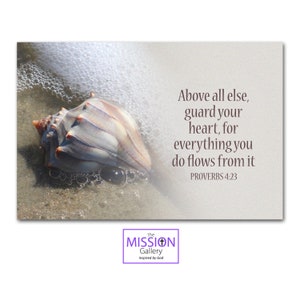 May include: A seashell on a sandy beach with foamy waves. The text reads: "Above all else, guard your heart, for everything you do flows from it. Proverbs 4:23".