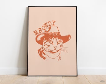 Peut inclure: Illustration numérique d'un chat portant un chapeau de cowboy. Le chat est orange et blanc et a une expression amicale. Le texte "MEOWDY" est écrit au-dessus du chat dans une police de caractères de style vintage.