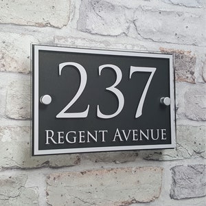 May include: Black and white house number sign with the number 237 and the text "Regent Avenue" on a grey background.