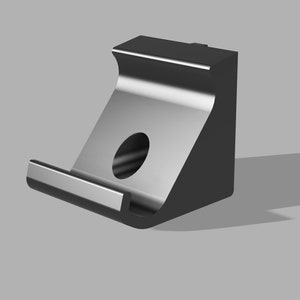 Op de afbeelding: Een zwarte metalen beugel met een afgeronde rand en een gat in het midden. De beugel is ontworpen om aan een muur of ander oppervlak te worden gemonteerd.