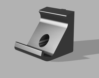 May include: A black metal bracket with a rounded edge and a hole in the center. The bracket is designed to be mounted to a wall or other surface.