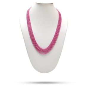 May include: A multi-strand necklace made of pink gemstone beads. The necklace is displayed on a white mannequin bust.