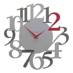 May include: A modern wall clock with a gray face and red hands. The numbers are in a unique, overlapping design, with the number 2 in red. The clock face has the text "CaleoDesign" and "made in italy".
