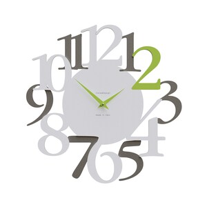 May include: A modern wall clock with a white face and a unique design. The clock features gray, white, and green numbers that appear to float around the face. The clock hands are a bright green color. The text "CallisaDesign" and "made in italy" are printed on the clock face.