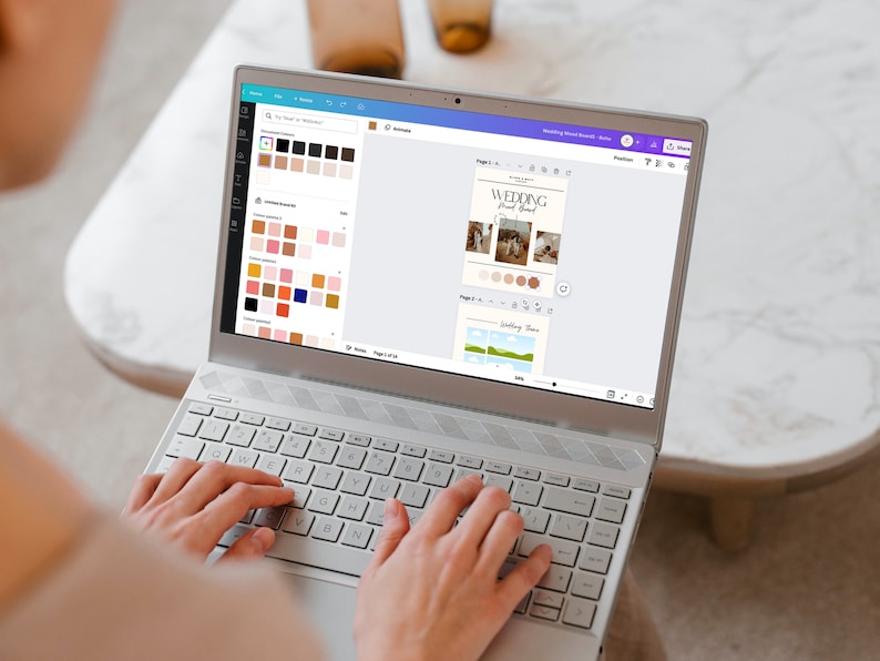 May include: A person using a laptop to design a wedding invitation. The screen shows a template with photos, text, and color palettes. The text on the screen reads "Wedding Weekend Schedule".