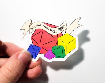 May include: A sticker featuring a banner that reads "Never too many dice... Right?" and five colourful dice in various shapes and sizes.