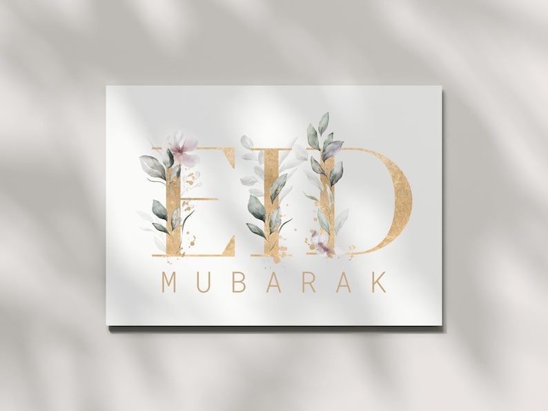 May include: A white card with gold lettering that says "Eid Mubarak" with floral accents.