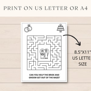 K&ouml;nnte beinhalten: Ein schwarz-wei&szlig;es, druckbares Hochzeit-Labyrinth-Spiel mit dem Text "Kannst du der Braut und dem Br&auml;utigam helfen, aus dem Labyrinth zu kommen?" Das Labyrinth zeigt im Zentrum eine Braut und einen Br&auml;utigam sowie oben einen Ehering und eine Torte. Das Spiel ist f&uuml;r den Druck auf Papier im US-Letter-Format (8,5" x 11") konzipiert.