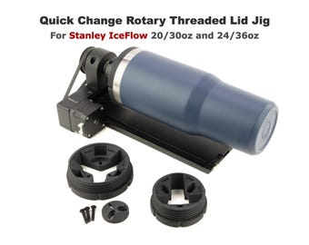 May include: A black rotary threaded lid jig for Stanley IceFlow 20/30oz and 24/36oz tumblers. The jig has a black belt and a blue tumbler in the image. There are two black plastic rings with a three-pronged design.