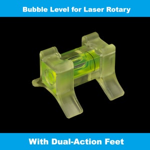 May include: A clear plastic bubble level with a green liquid and a bubble in the centre. The level has two clear plastic feet that can be adjusted to level surfaces. The level is designed for use with laser rotary equipment.