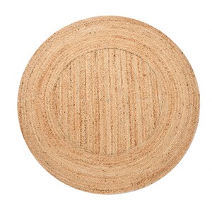 May include: A circular rug made from natural jute, showcasing a woven texture and a light brown hue. The design includes a defined circular border and a vertically striped central pattern. Ideal for various rooms, such as living rooms or bedrooms.