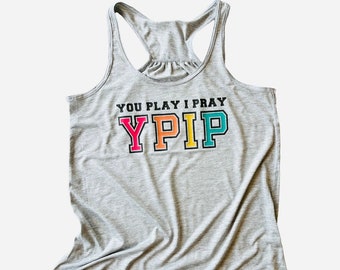 May include: Gray tank top with the text "You Play I Pray" and the acronym "YPIP" in colorful block letters.