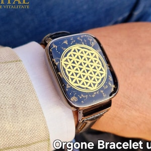 May include: A black leather bracelet with a gold-coloured flower of life design. The bracelet is labelled "Orgone Bracelet unisex with Translighters structures "BLAGA" & "SUPER" by Svetlana Lungu".