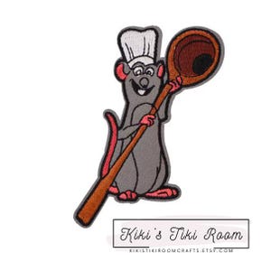 May include: A gray rat wearing a white chef's hat holds a wooden spoon with a brown bowl. The rat is smiling and has a red nose. The spoon is held in the rat's right hand.