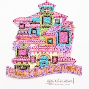 May include: Embroidered iron-on patch featuring a colorful multi-level house with a blue door and the text "Family is Everything".