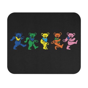 May include: Black rectangular mousepad featuring five dancing bears in blue, green, yellow, orange, and pink. Each bear has a unique color and design, with a matching color around their neck.