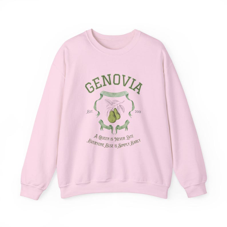 May include: Pink sweatshirt with a green graphic print of a crest with the text "GENOVIA" and the years "1881" and "2001". The crest also includes a drawing of two pears and the text "A Queen is "Never Late" Everyone Else is Simply Early".