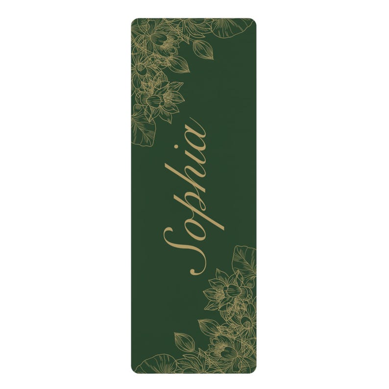 May include: A rectangular dark green yoga mat featuring a gold-colored line art illustration of lotus flowers in the top left and bottom right corners. The name Sophia is printed in a large, elegant gold-colored script font in the center.