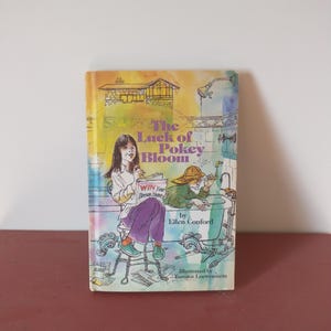 May include: A book cover with a colorful illustration of two children. The book title is "The Luck of Pokey Bloom" and the author is Ellen Conford. The book is illustrated by Bernico Loewenstein.