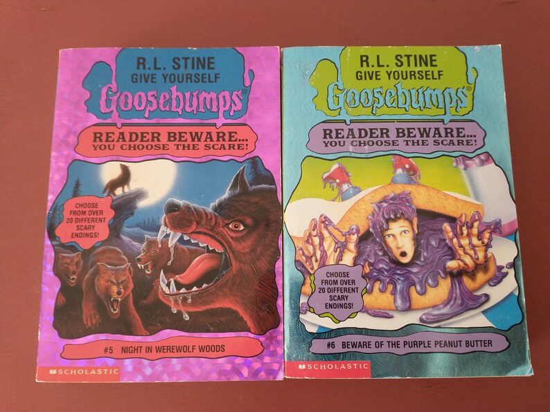 May include: Two Goosebumps books with a purple and blue cover. The book on the left has a werewolf on the cover and the text "Night in Werewolf Woods #5". The book on the right has a boy covered in purple peanut butter on the cover and the text "Beware of the Purple Peanut Butter #6".
