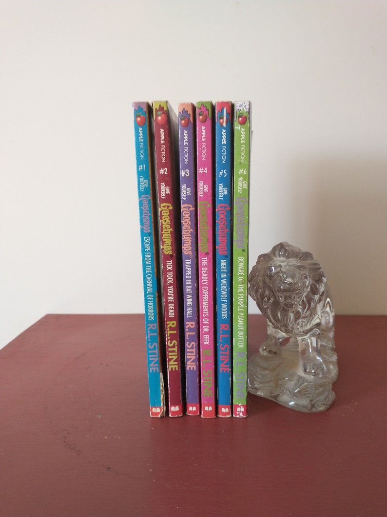 May include: A set of six Goosebumps books by R.L. Stine, featuring colorful covers with spooky illustrations. The books are arranged in order from #1 to #6, with titles like "Escape from the Carnival of Horrors" and "Night in Werewolf Woods".