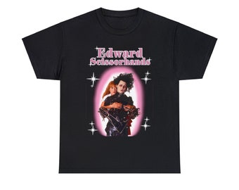 May include: Black t-shirt with a pink graphic of Edward Scissorhands and a woman. The text "Edward Scissorhands" is in pink letters.