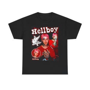 May include: Black t-shirt featuring a graphic of Lil Peep with the text "Hellboy". The design includes a portrait of Lil Peep, a dove, and the words "Cry Baby". The shirt is a crew neck.