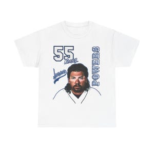 May include: White t-shirt featuring a blue and white graphic of a baseball player with the number 55 and the name Kenny Powers.