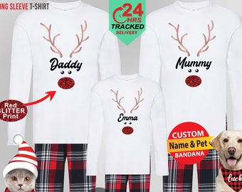 May include: White long-sleeved shirts with red glitter reindeer designs and matching red and black plaid pajama pants. The shirts say "Daddy", "Mummy", and "Emma". A dog wearing a red bandana with the word "Lucky" is also pictured.