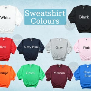May include: A collection of crewneck sweatshirts in various colors, including white, black, red, navy blue, gray, pink, orange, green, maroon, and royal blue. The text "Sweatshirt Colours" is displayed in a light blue rectangle.