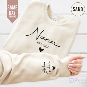 May include: A cream coloured sweatshirt with the text "Nana Est. 2024" and a small heart on the front. The left sleeve has the text "Arthur Sophia" and a heart.
