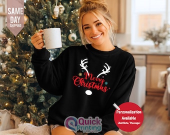 May include: A black sweatshirt with a white reindeer antler design and the words "Merry Christmas" in red. The sweatshirt is part of a holiday collection and is perfect for the Christmas season.
