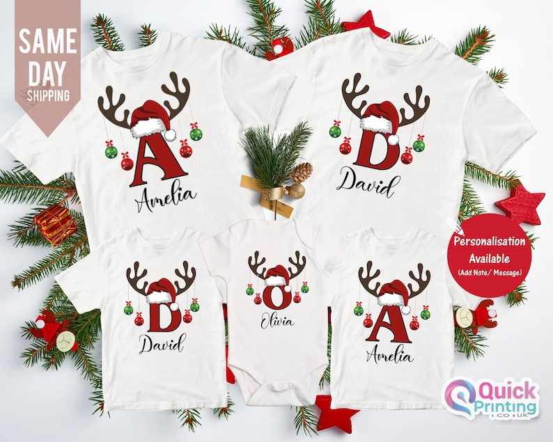 May include: White Christmas family t-shirts with reindeer antlers, Santa hats, and personalized names. Each shirt features a letter and name, with red and green ornaments. The image also includes the text "Personalisation Available".