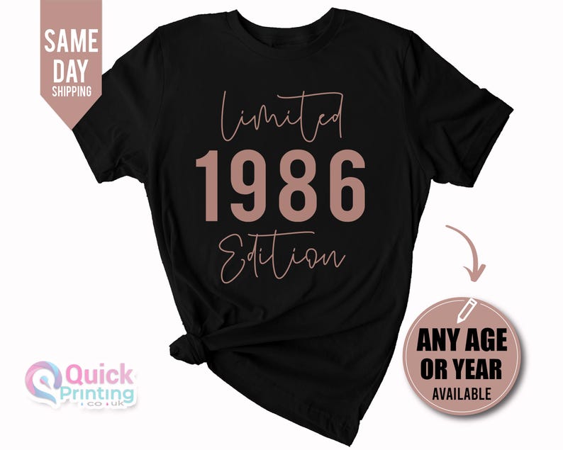 May include: A black short-sleeve t-shirt featuring the text Limited Edition in a cursive font with the year 1986 in a large bold sans-serif font in the center. The text is printed in a muted rose gold color on the front of the garment.