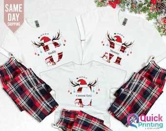 May include: White Christmas-themed family pajama sets with matching plaid pants. The shirts feature a reindeer design with a Santa hat and the words "Daddy", "Mummy", and "Custom Text". The image also includes the text "Same Day Shipping".