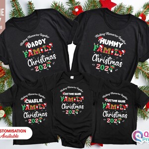 May include: Set of five black t-shirts with a Christmas theme. The shirts feature the text "Making Memories Together" and a family of elves with the words "Daddy", "Mummy", "Charlie", "Custom Name" and "Custom Name" above them. The shirts also feature the text "Family Christmas 2024".